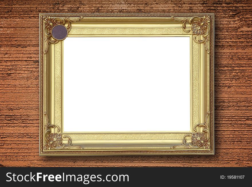 Gold picture frame on rough orange wall.