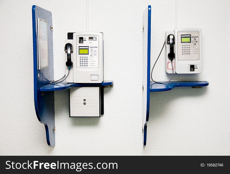 Two public telephone on wall