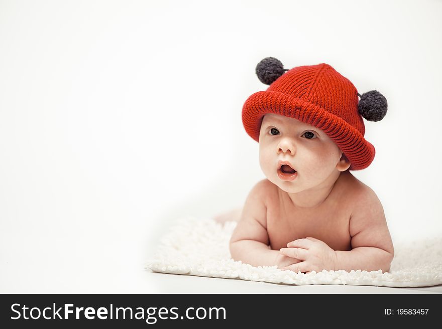 The little boy wearing the red hat