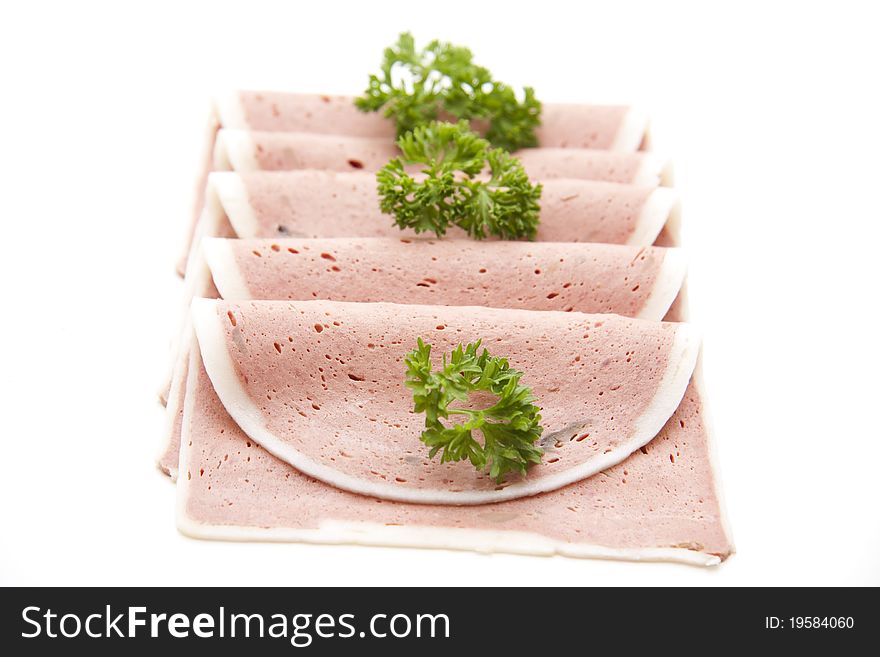 Liver sausage with parsley onto white background