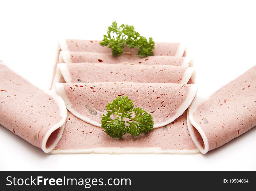 Liver sausage with parsley onto white background