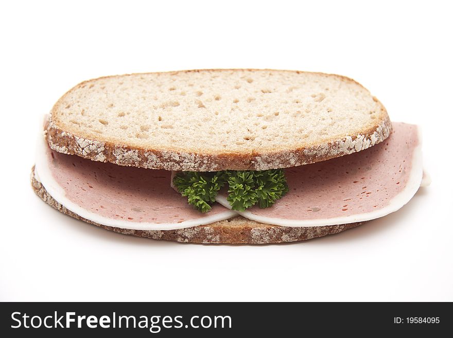 Liver sausage with parsley on wheat bread. Liver sausage with parsley on wheat bread