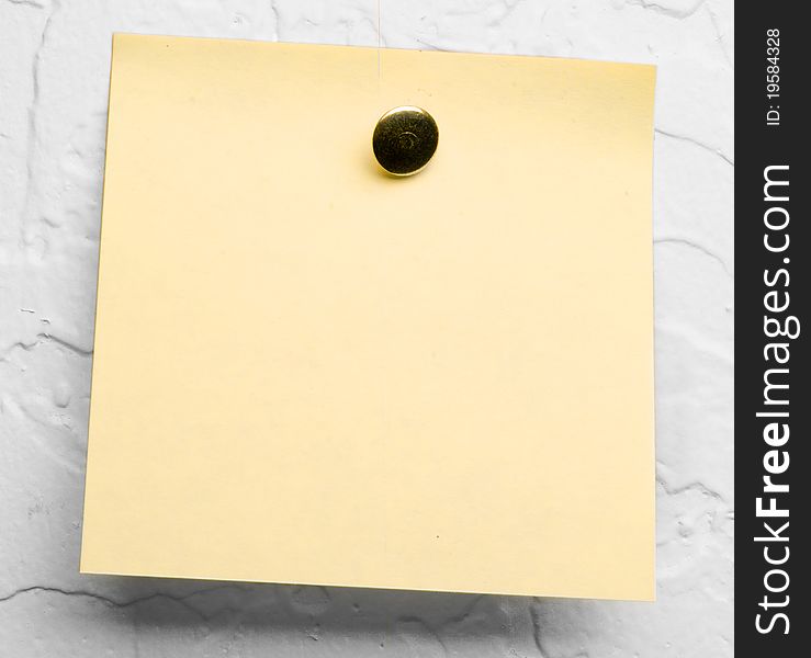 Yellow sticky note on a gray background
