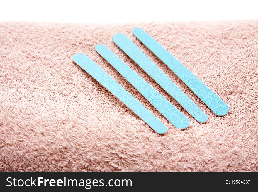 Blue fingernail files on terry cloth towel