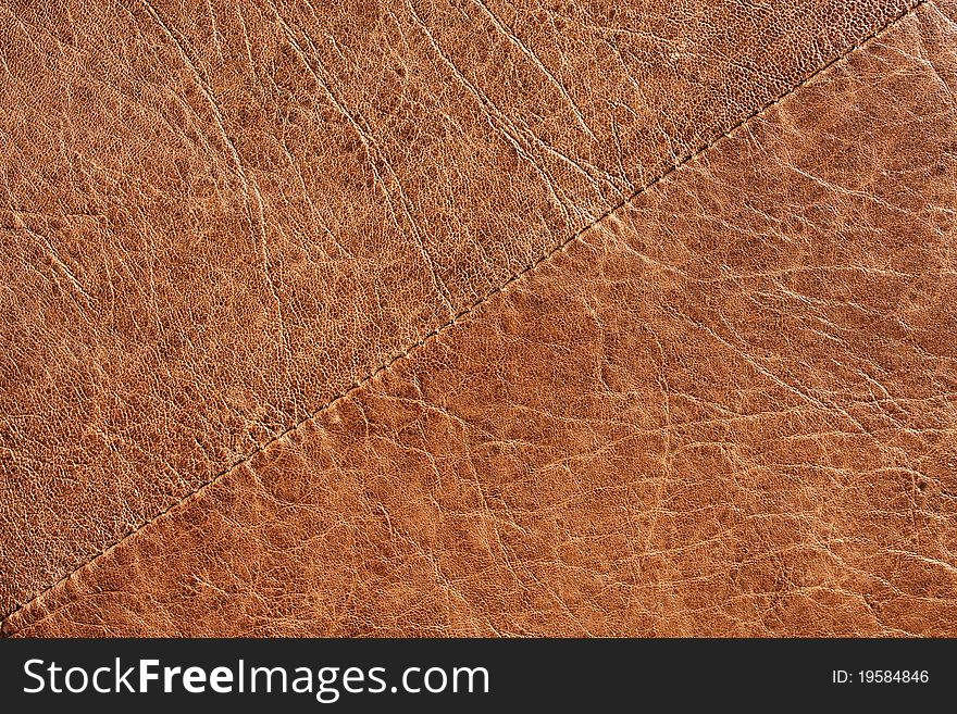 Brown leather texture / Brown leather with stitching going across and diagonal.