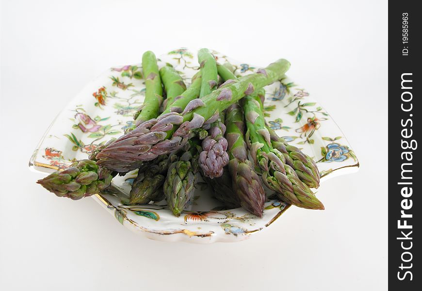 Dish of fresh asparagus isolated on a white background. Dish of fresh asparagus isolated on a white background