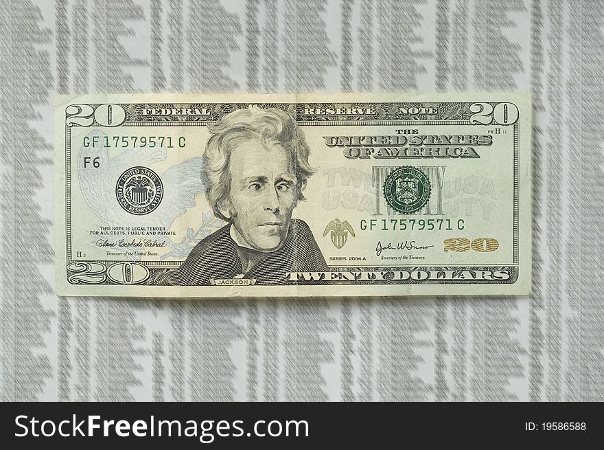 Twenty dollar bill with picture of Jackson with a crazy face, on the stock market paper as a background. Twenty dollar bill with picture of Jackson with a crazy face, on the stock market paper as a background.