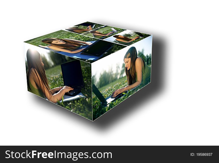 Portrait of a cute young female lying on the grass in the park using a laptop composed in box style. Portrait of a cute young female lying on the grass in the park using a laptop composed in box style