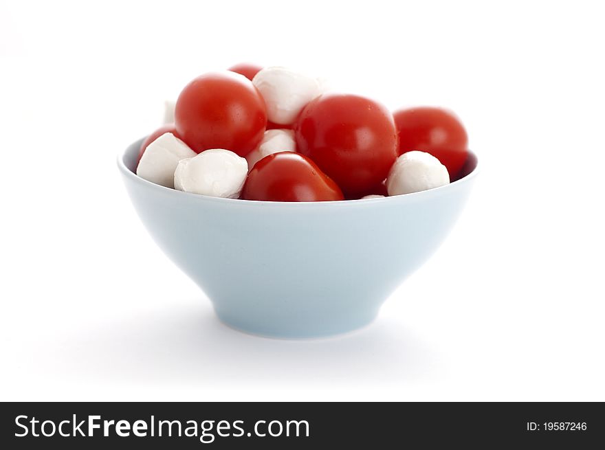 Mozarella and tomatoes isolated on white background. Mozarella and tomatoes isolated on white background