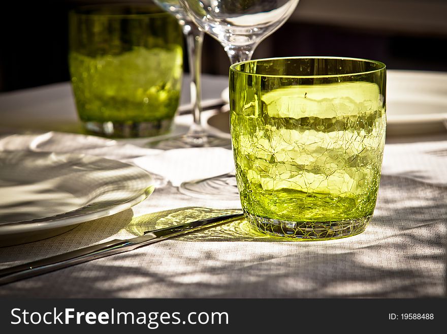 Close-up on glasses on a table set in an outdoors restaurant. Close-up on glasses on a table set in an outdoors restaurant.