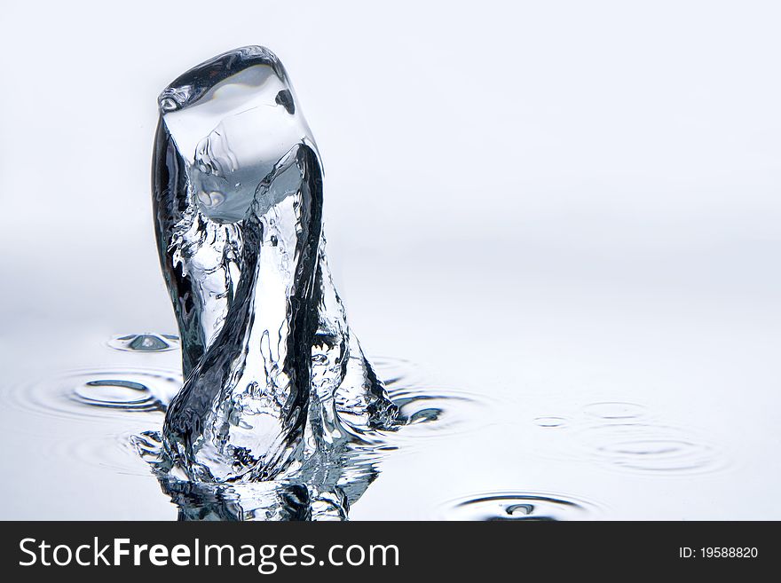 A background with a view of a dropped ice-cube doing underwater. A background with a view of a dropped ice-cube doing underwater