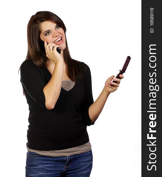 Young woman on her cell phones seeming to communicate in two conversations