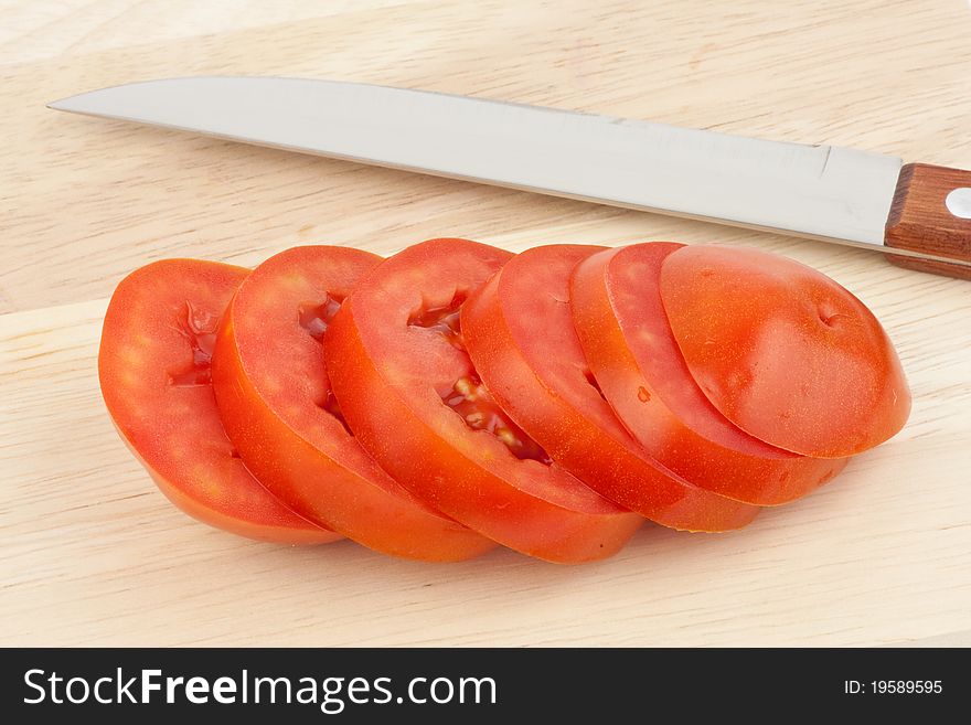 Chopped tomato on chopping block
