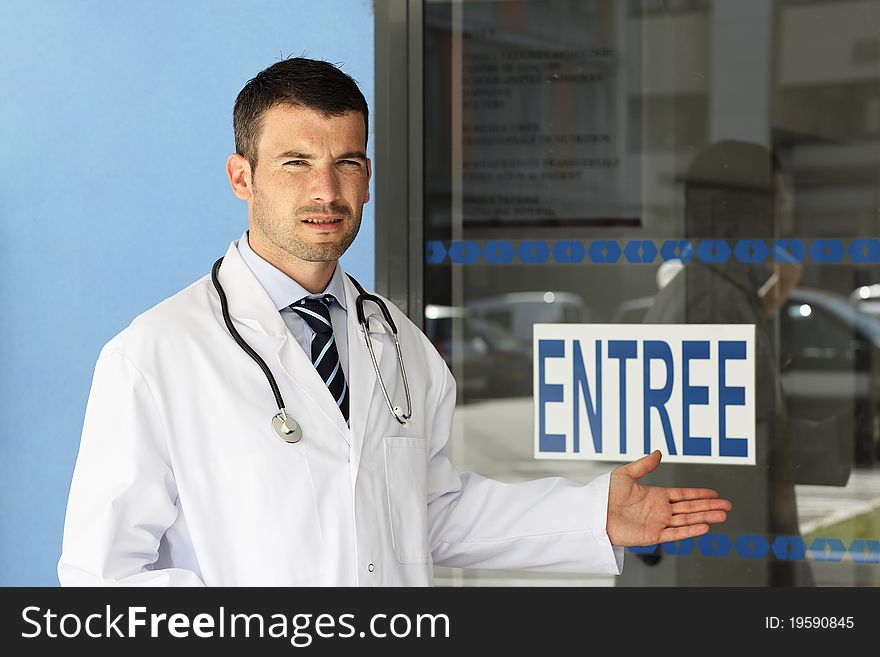 Young doctor in front of hospital entry. Young doctor in front of hospital entry