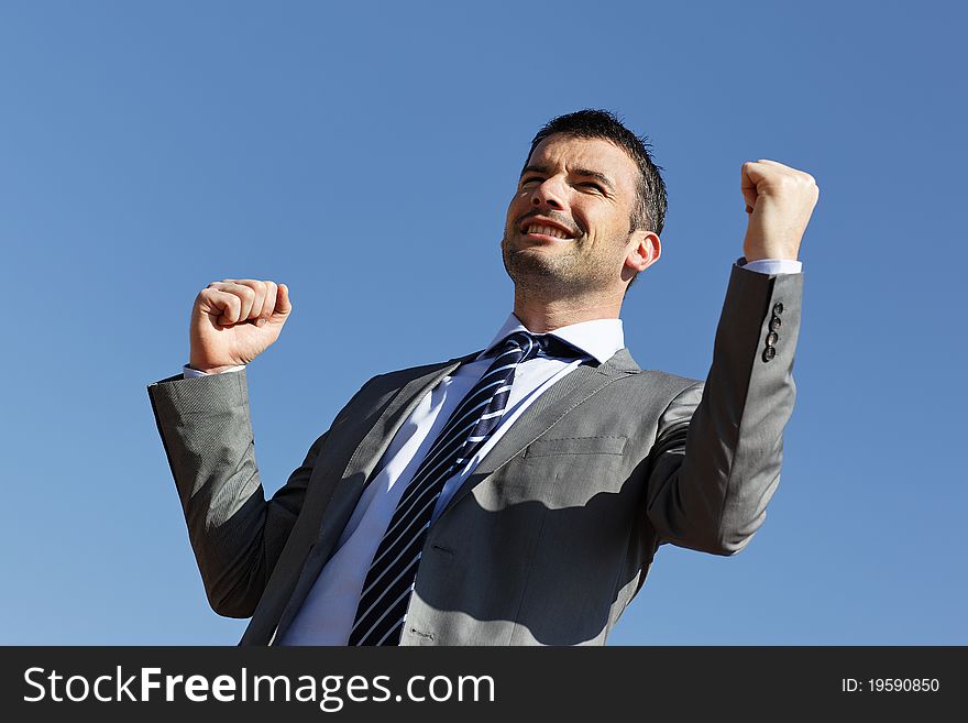 Young businessman and blue sky in summer. Young businessman and blue sky in summer