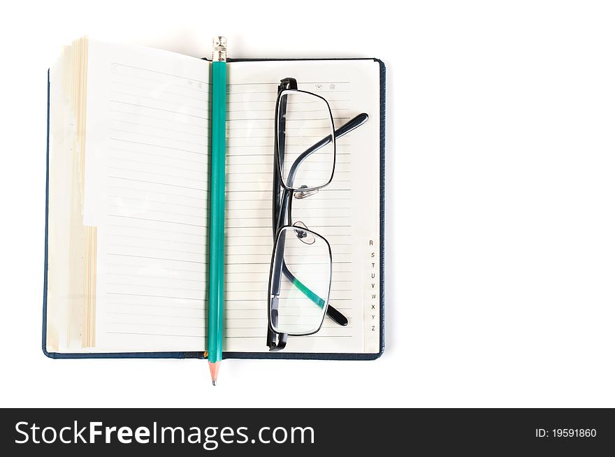 Notebook and eyeglasses isolated on a white background