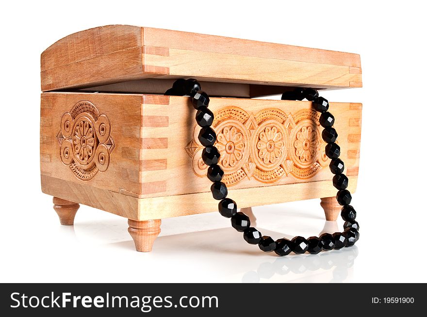 Wooden casket with jewelry isolated on a white background