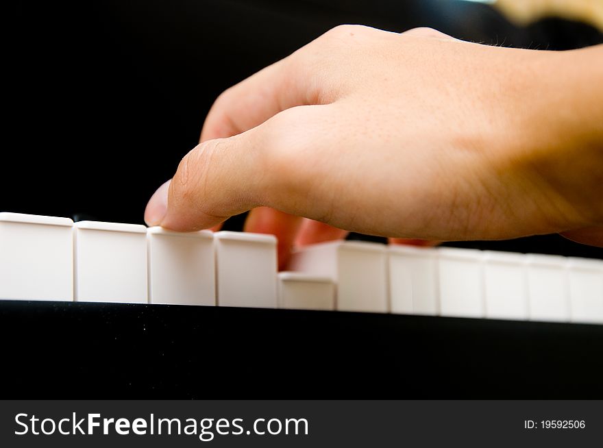 Hand playing on piano keys. Hand playing on piano keys