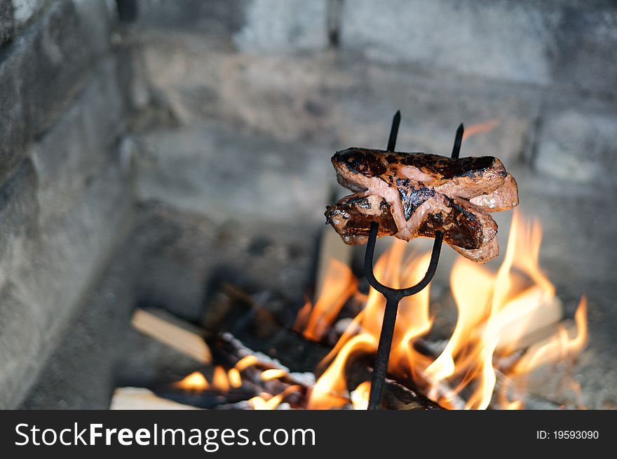 Sausage roasted over a fire in the fireplace. Sausage roasted over a fire in the fireplace