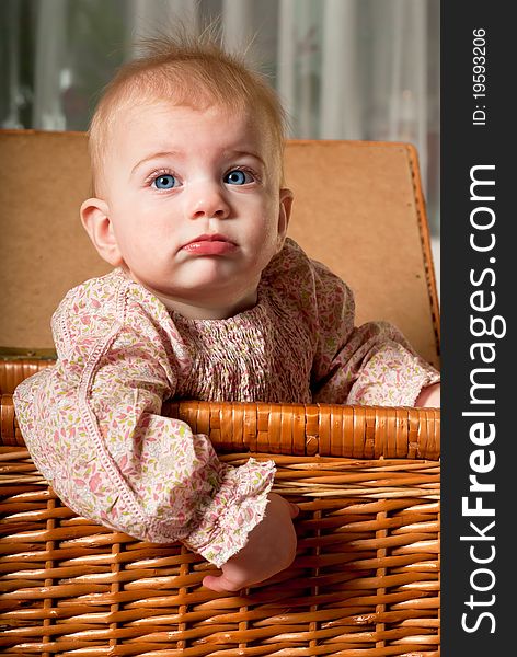 Closeup portrait of little cute baby girl in basket. Closeup portrait of little cute baby girl in basket