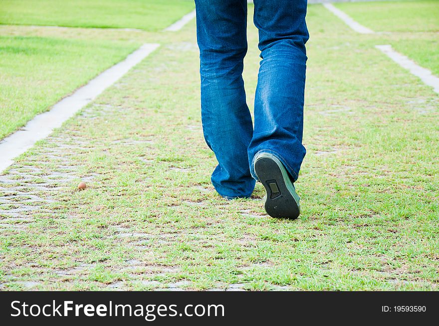 Man walking on grass footpath