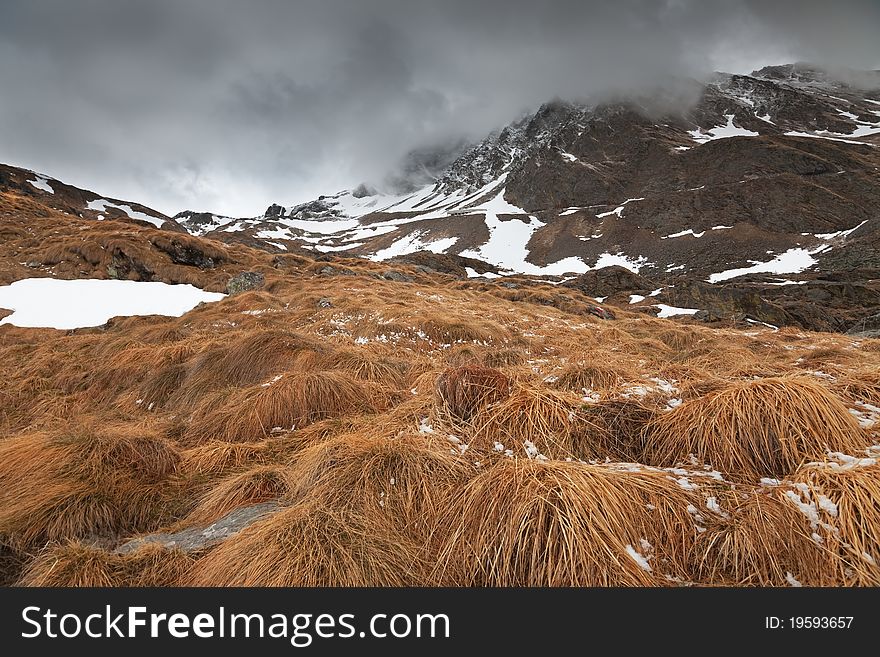 Icy Valley. Top of Valle delle Messi, Brixia province, Lombardy region, Italy. Pietra Rossa Pass (2890 meters on the sea-level) as background