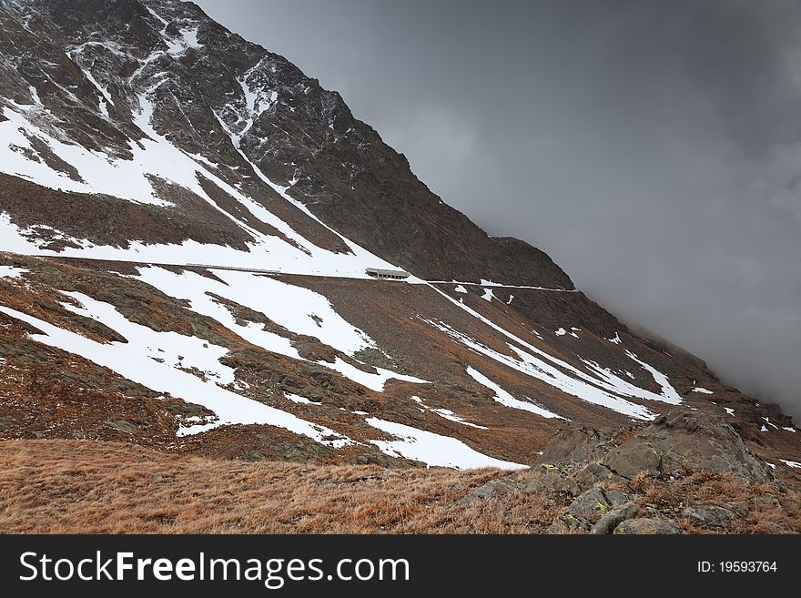 Road to Gavia Pass during winter. 2400 meters on the sea-level. Tarmac is under deep snow. Brixia province, Lombardy region, Italy