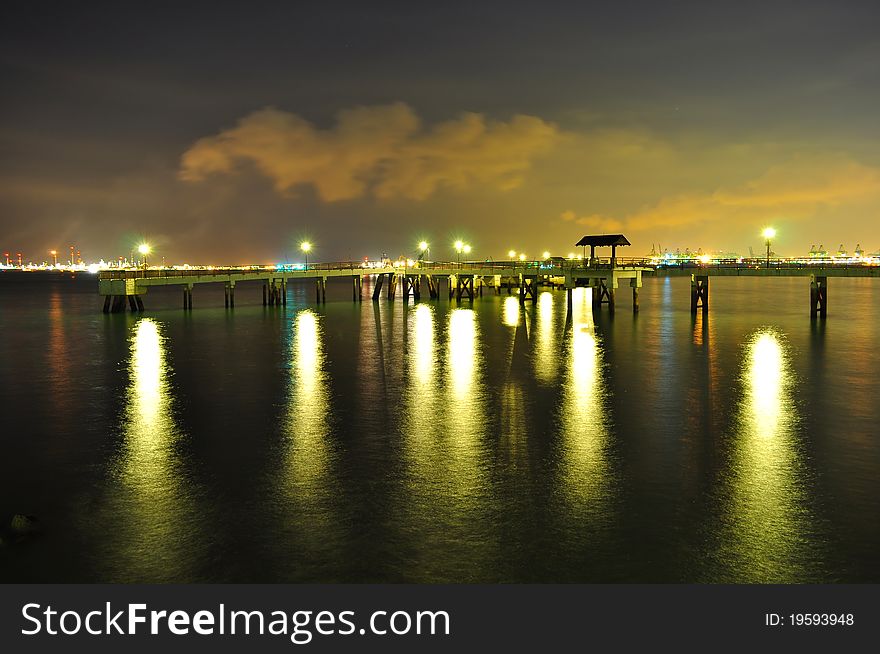 End of Labrador Park Jetty (Singapore) with lights reflection on the water, by night. End of Labrador Park Jetty (Singapore) with lights reflection on the water, by night