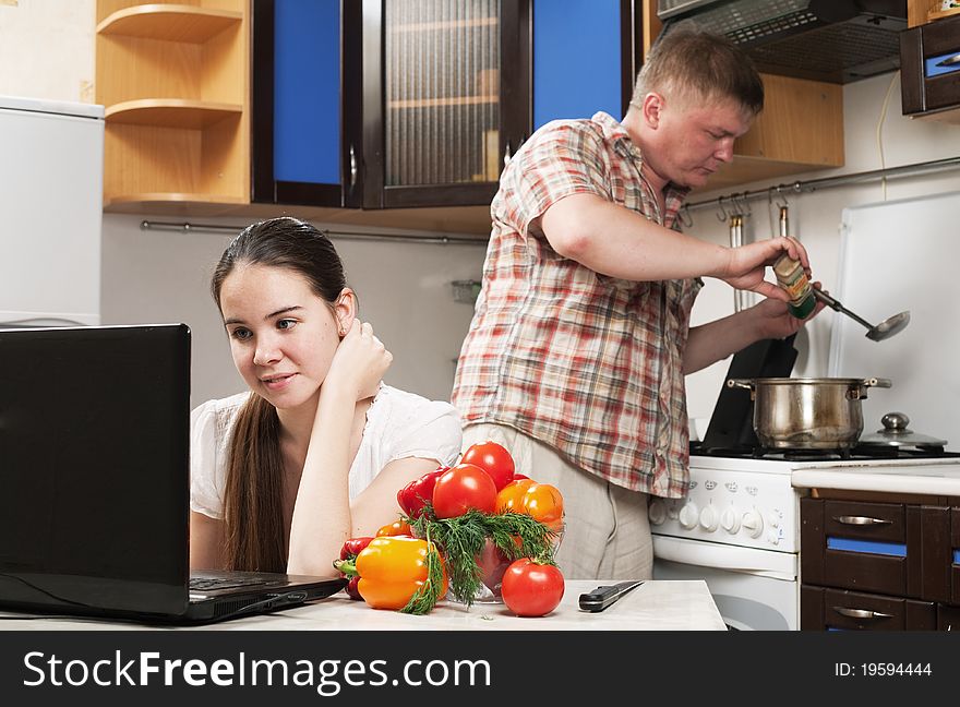 Young beautiful caucasian woman in the kitchen with vegetable