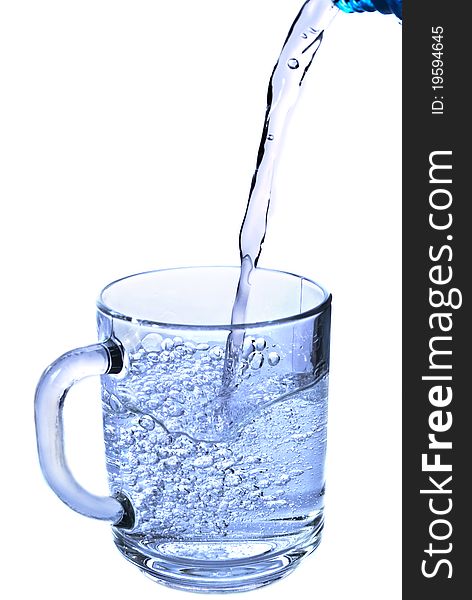 pouring water in a glass isolated against white background. pouring water in a glass isolated against white background