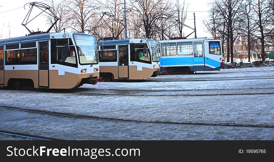 Photo of three trams in a winter city