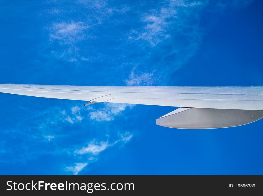 White airplane wing on clear blue sky. White airplane wing on clear blue sky