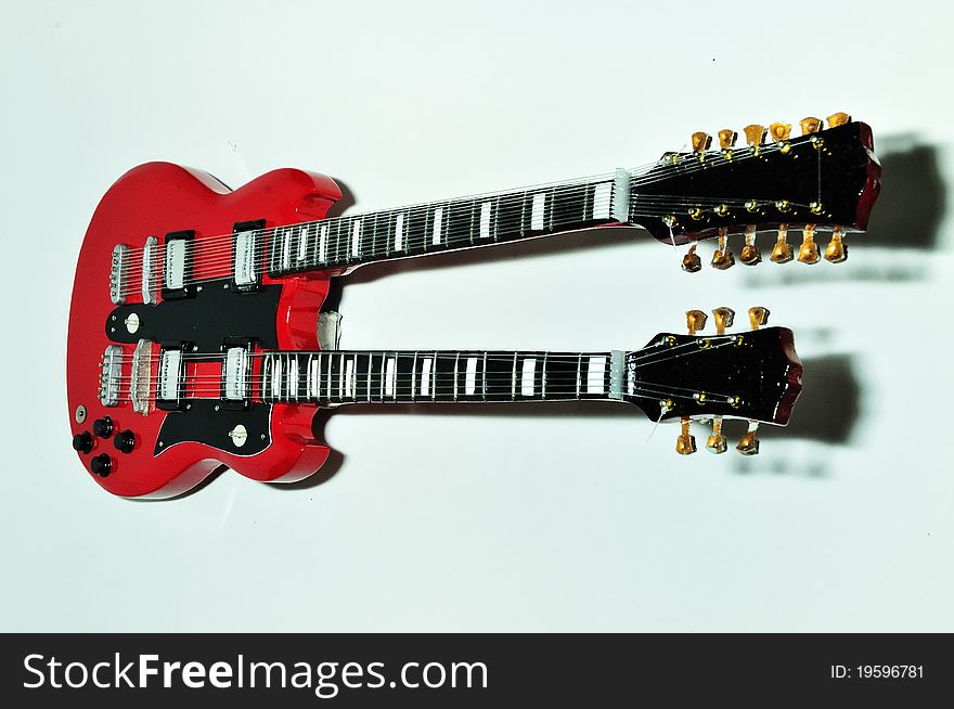 A red guitar on the white background. A red guitar on the white background