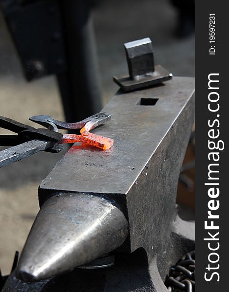 A blacksmith at work with red-hot iron. A blacksmith at work with red-hot iron.