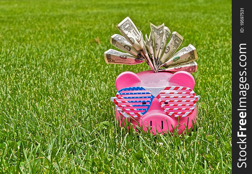 Piggy bank on the field of grass. Piggy bank on the field of grass