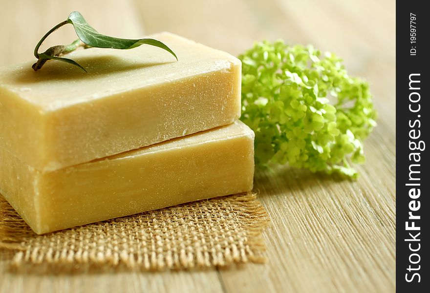 Two Soap And Green Leaf On Wooden