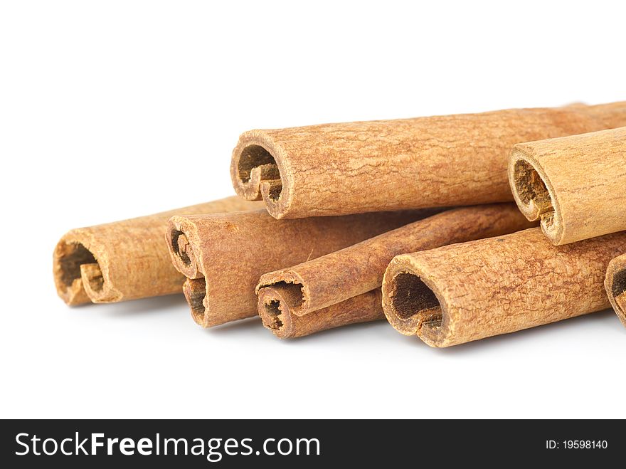 Few cinnamon sticks close-up.  Isolated on the white background