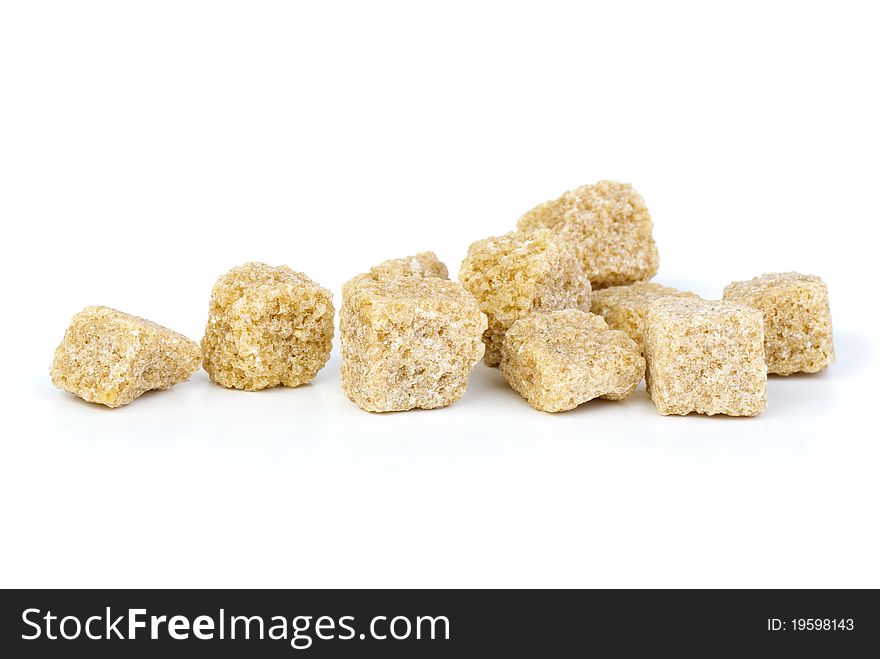 Few pieces of brown sugar  isolated on the white background