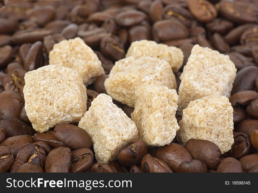 Few Pieces Of Brown Sugar And Coffee Beans