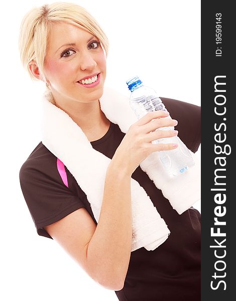 A young female dressed in gym clothes drinking water on white isolated background. A young female dressed in gym clothes drinking water on white isolated background