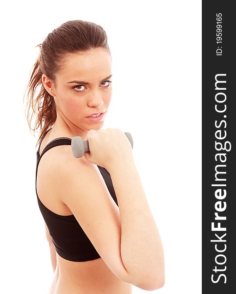 A young female dressed in gym clothes performing an arm curl exercise on isolated white background