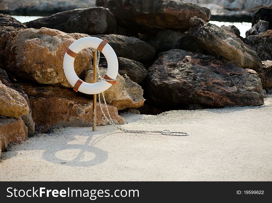 Lifebuoy hangs on a stick on the beach