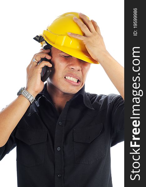 Workers wearing safety helmet tension while talk on mobile phone isolated white background. Workers wearing safety helmet tension while talk on mobile phone isolated white background