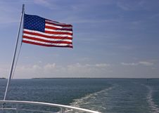 Speedboat And Wake And Flag Royalty Free Stock Photo