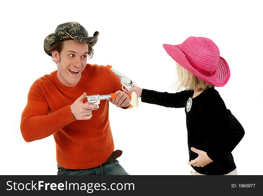 Father and five year old daughter wearing cowboy hats and laughing. Father and five year old daughter wearing cowboy hats and laughing