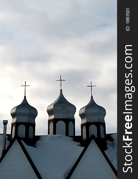 Close up of a church roof, christian cross and sky