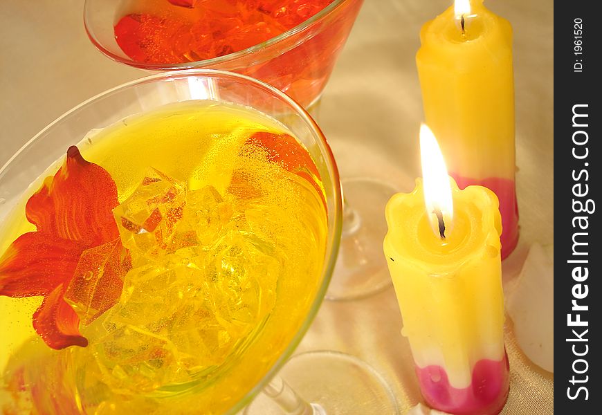 Yellow And Red Martini Glasses With Candles On Golden Background