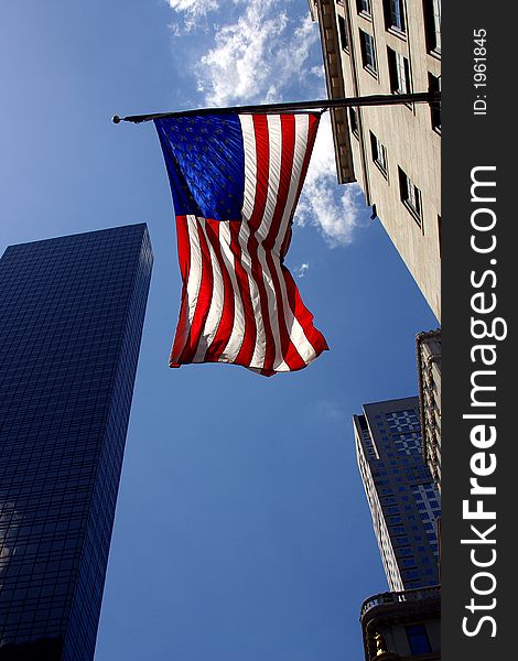 American flag and partial view of buildings in  New York City by day, United States, America. American flag and partial view of buildings in  New York City by day, United States, America