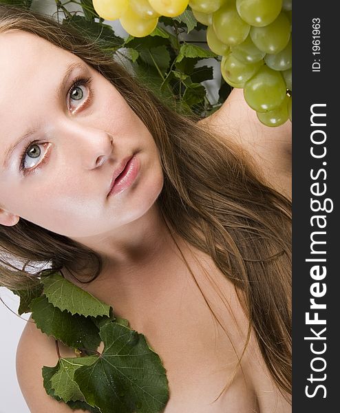 Beautiful young woman portrait with green grape. Beautiful young woman portrait with green grape