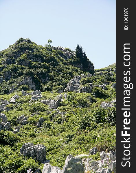 Rock, grass and sky at summer 2